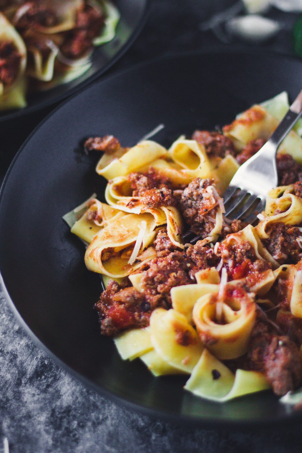 a bowl of elk bolognese sauce served over pappardelle pasta