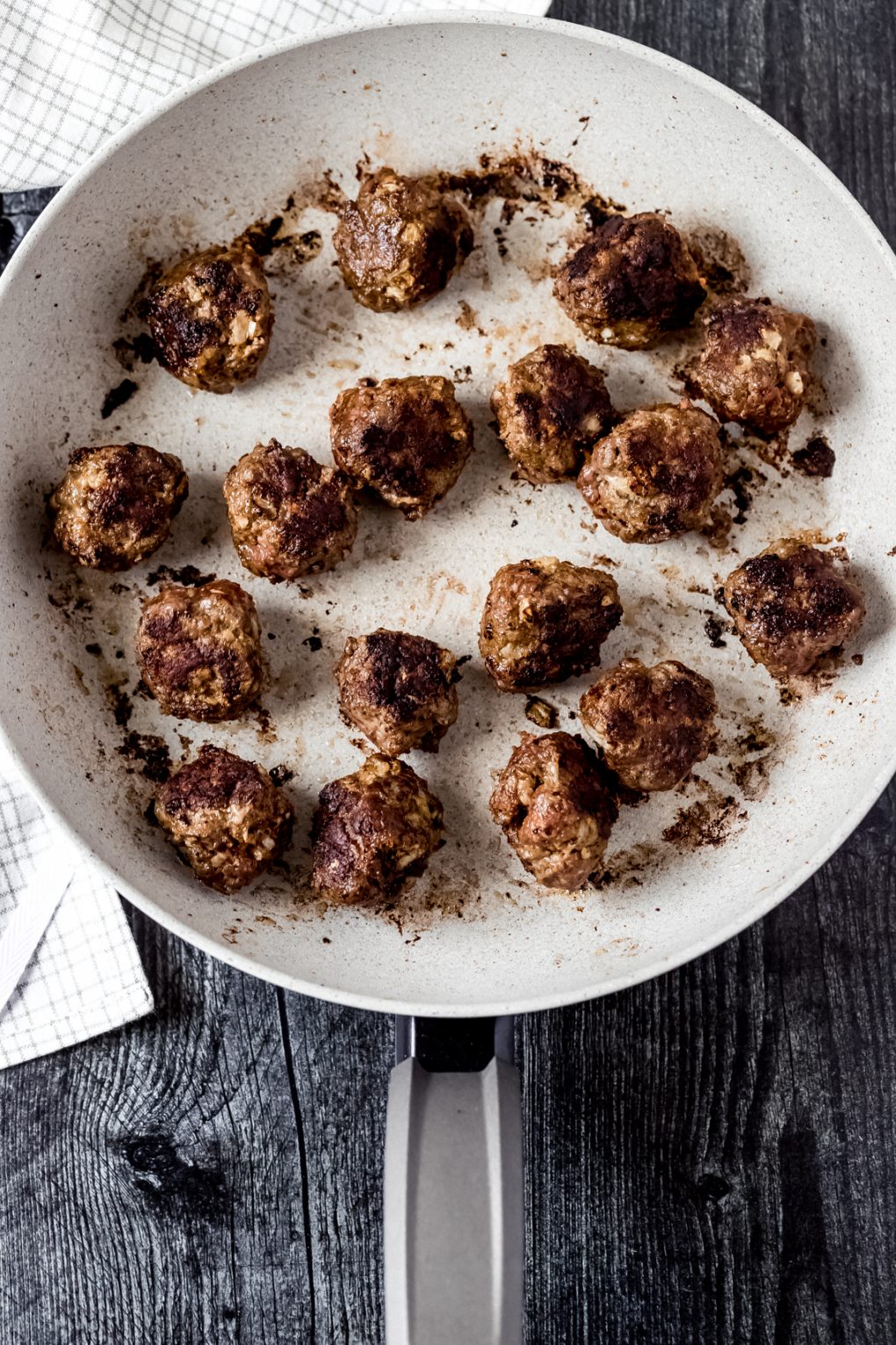 venison meatballs cooking in a skillet