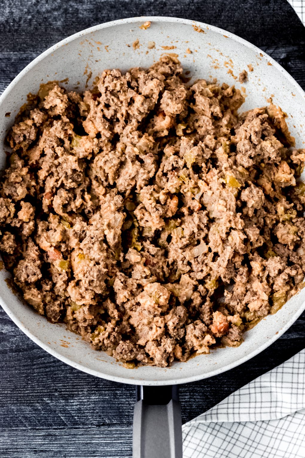 ground elk meat combined with refried beans in a skillet