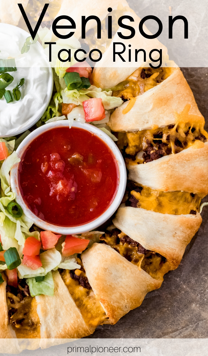 a venison taco ring with a bowl of salsa and sour cream in the middle