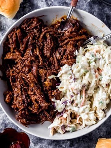 a serving bowl with elk BBQ brisket and spicy slaw