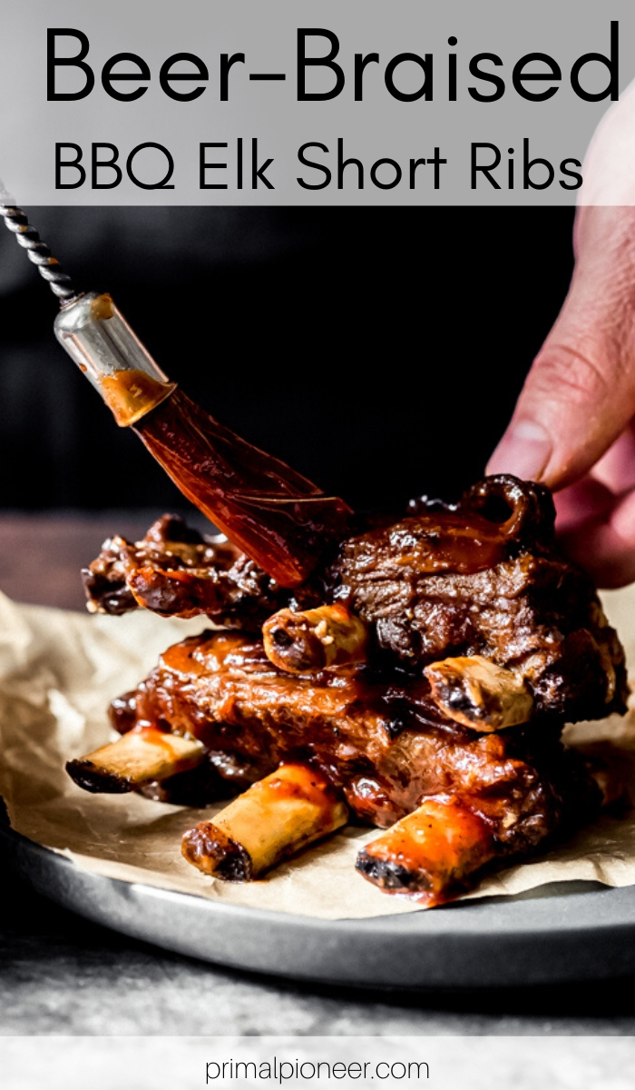 a man basting BBQ sauce on beer-braised elk short ribs