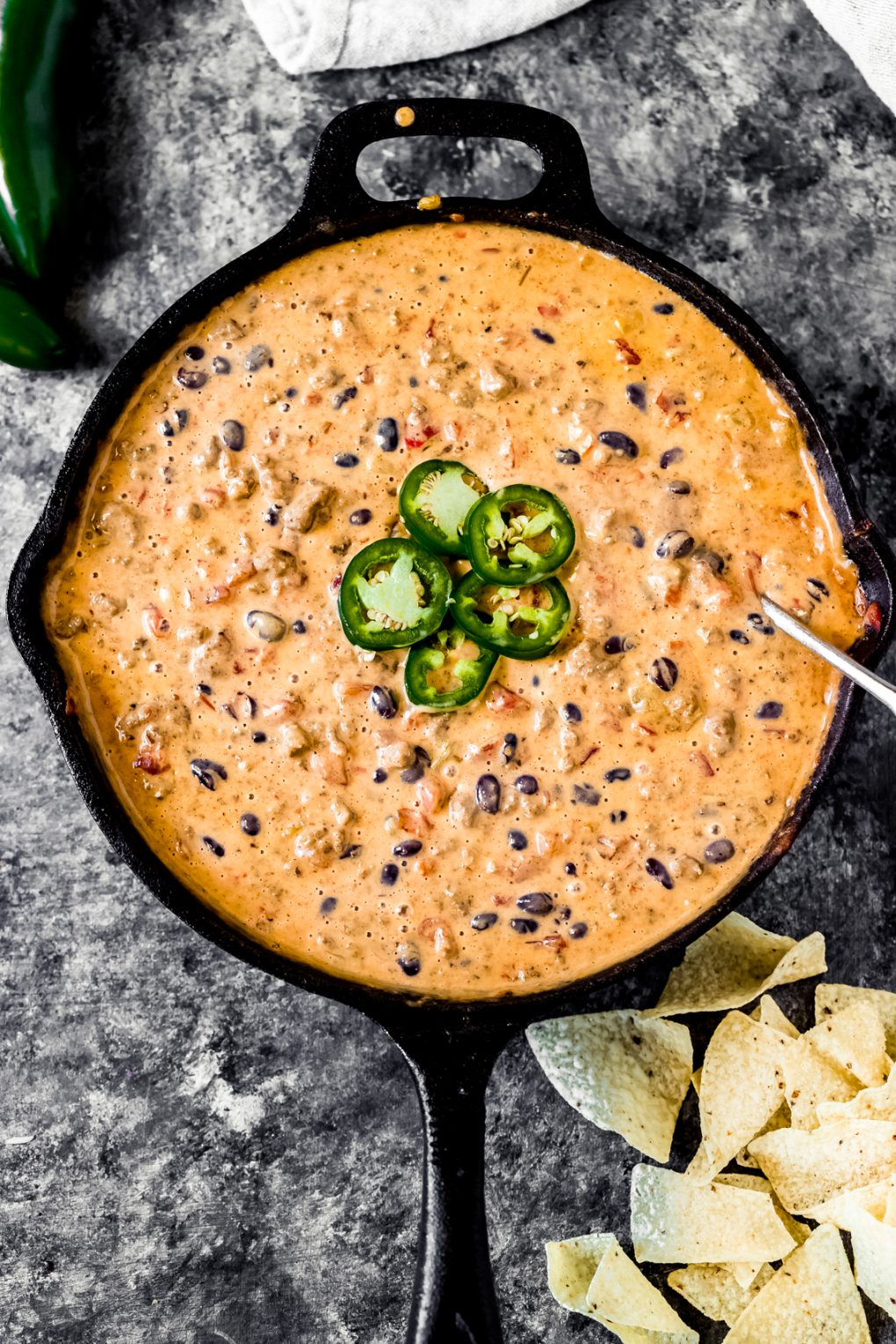 a skillet of loaded venison queso dip