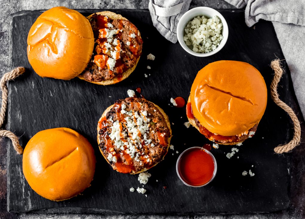 three spicy buffalo bison burgers on a tray