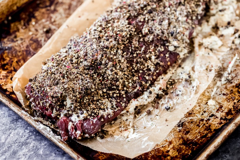 a peppercorn crusted elk tenderloin ready to be cooked