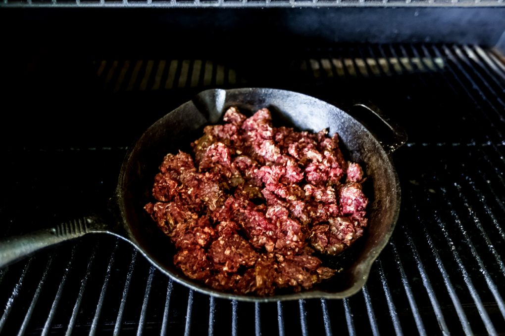 ground venison smoking on a Traeger grill
