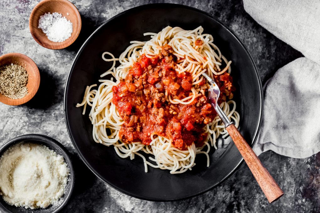 a bowl of spaghetti topped with homemade ground venison spaghetti sauce