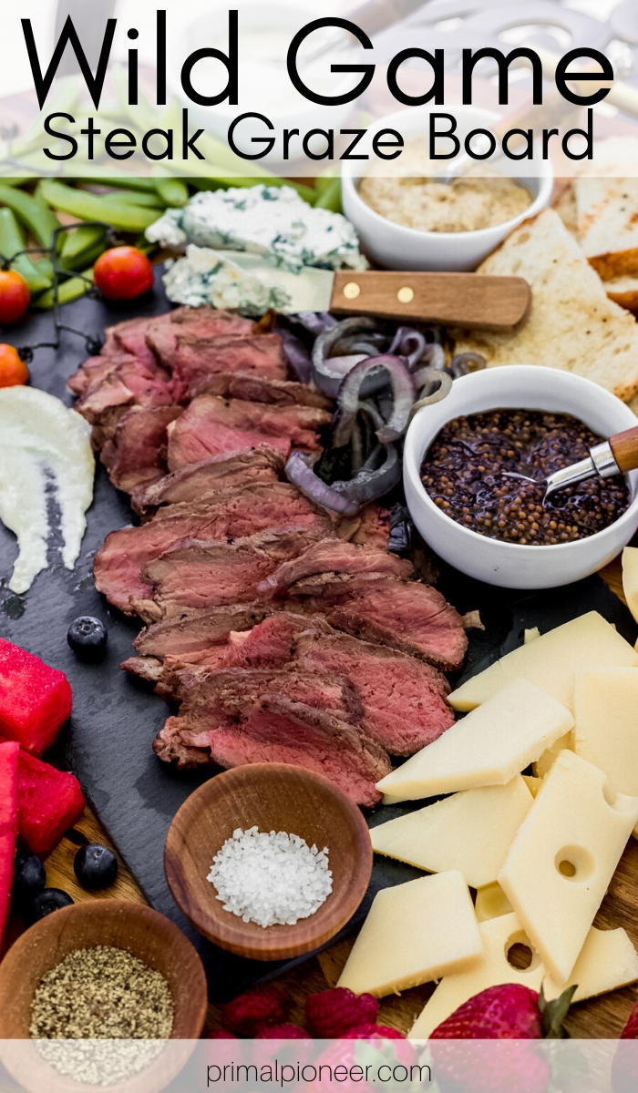a wild game steak graze board with fresh ingredients