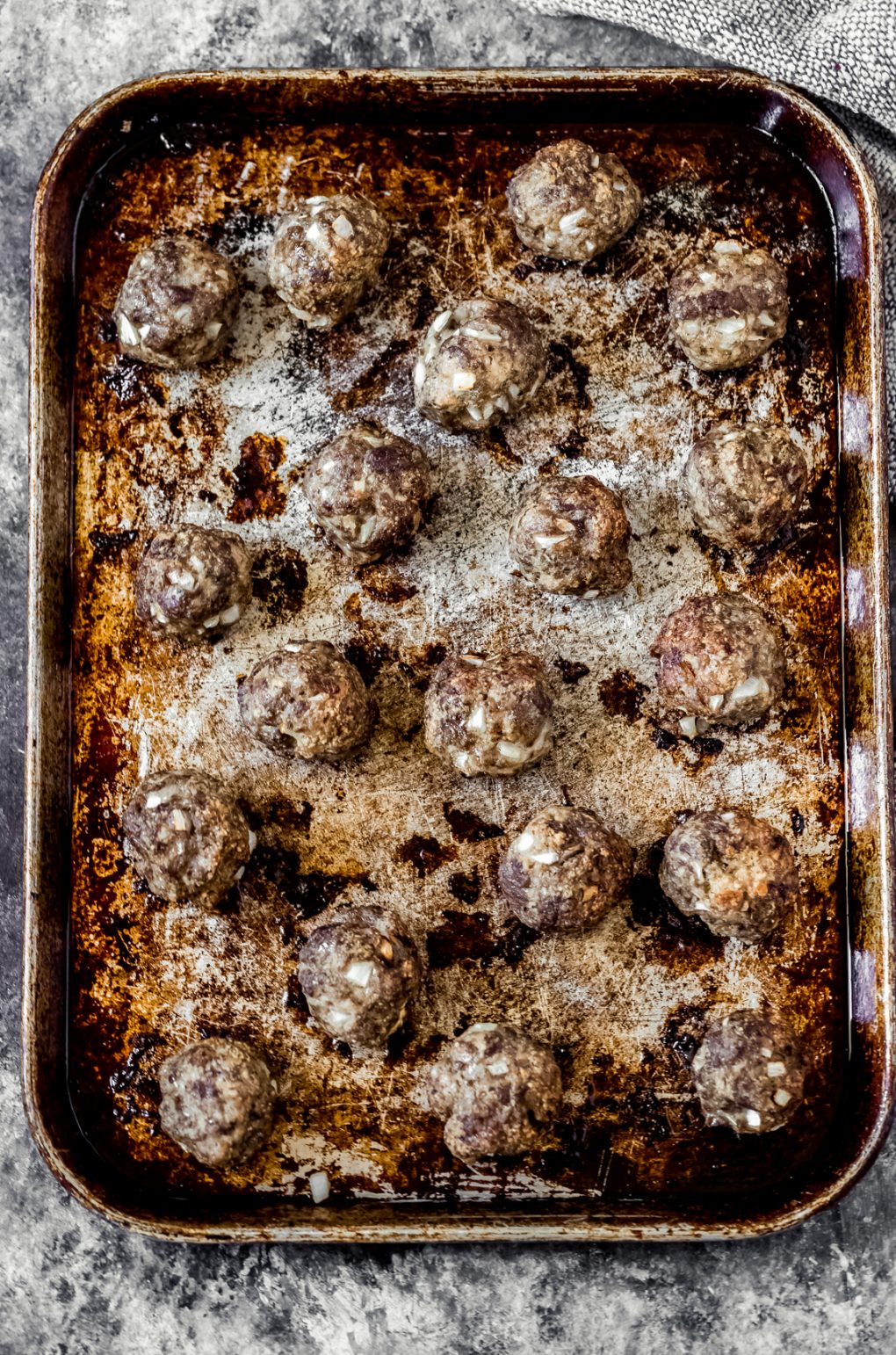 a pan of baked ground venison meatballs