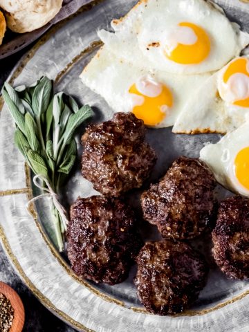 a platter of venison sausage patties and eggs