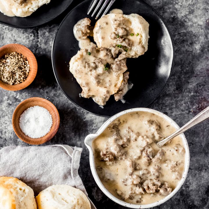 a bowl of country-style venison sausage gravy and a plate of biscuits and gravy