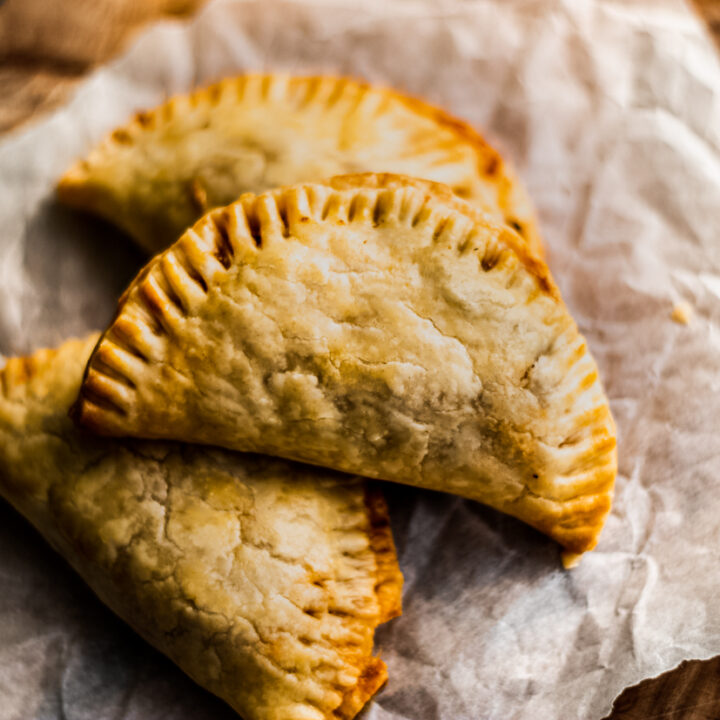 stacked empanadas on parchment paper