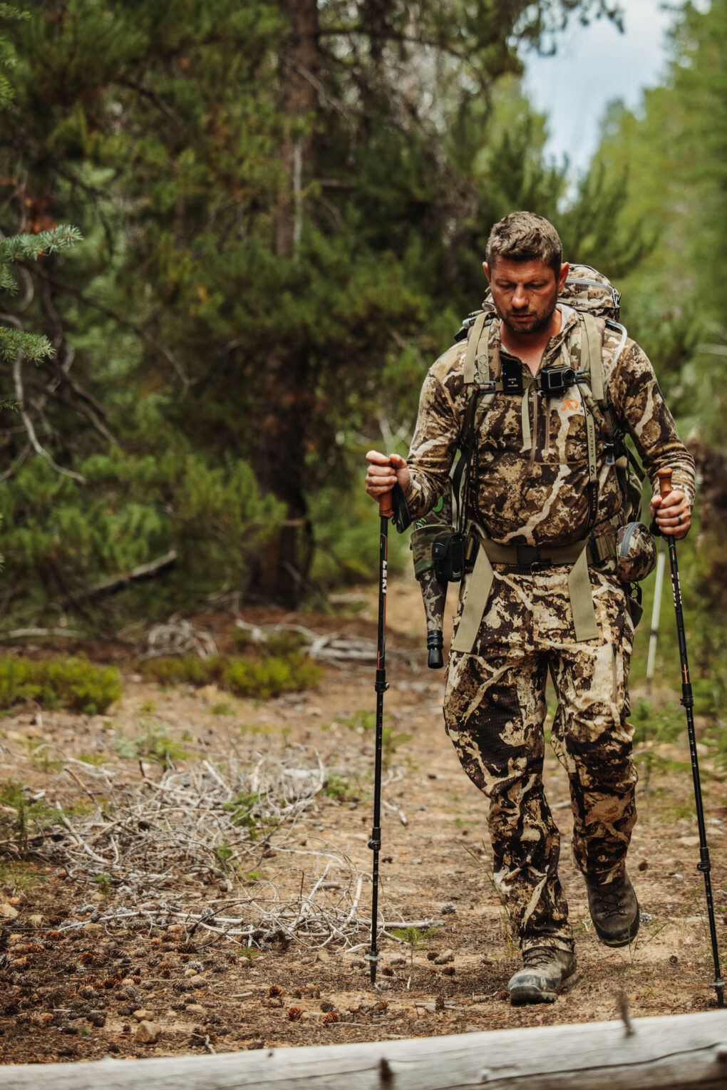 a man in first lite hunting apparel walking