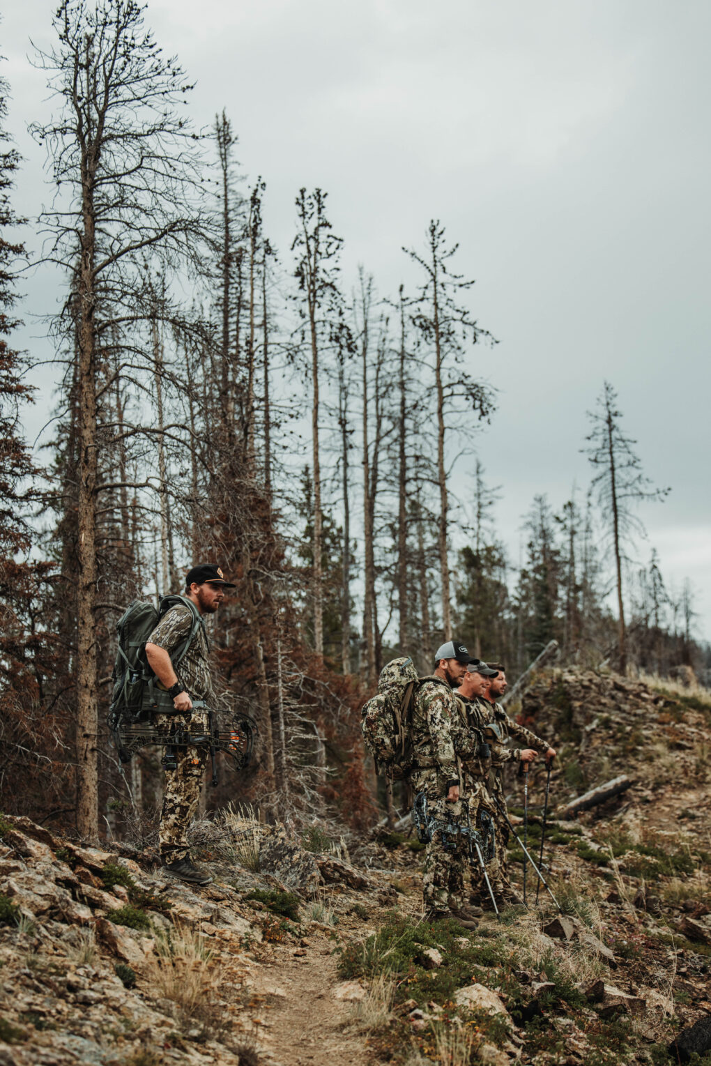 men on a mountain top hunting