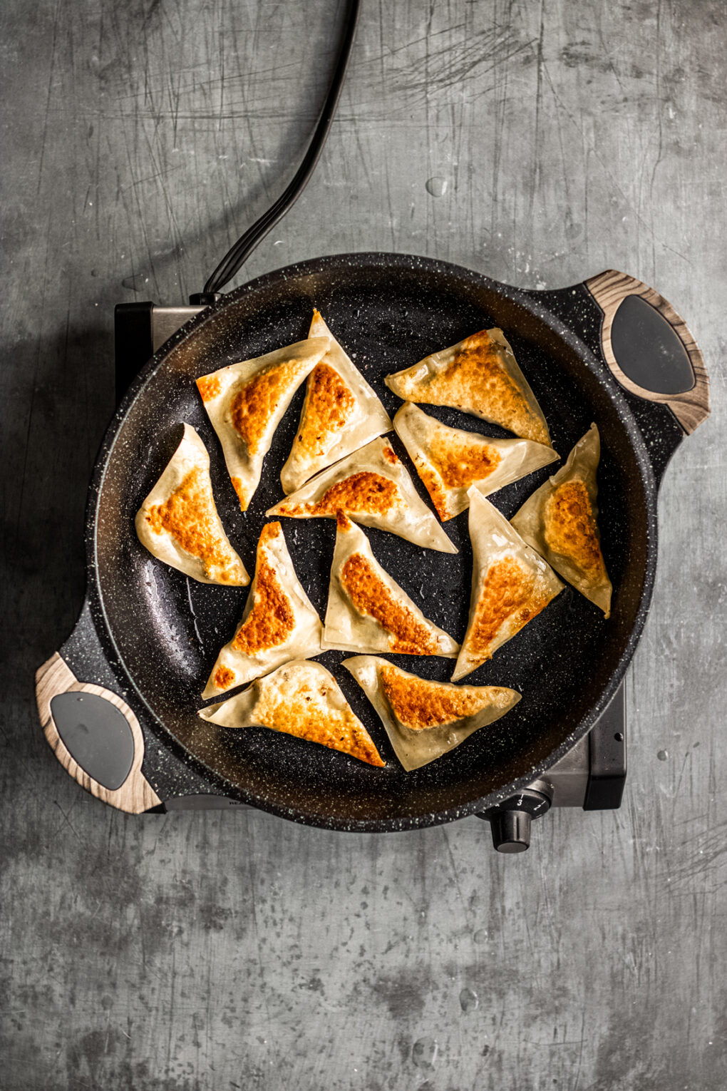 elk pot stickers cooking in a skillet