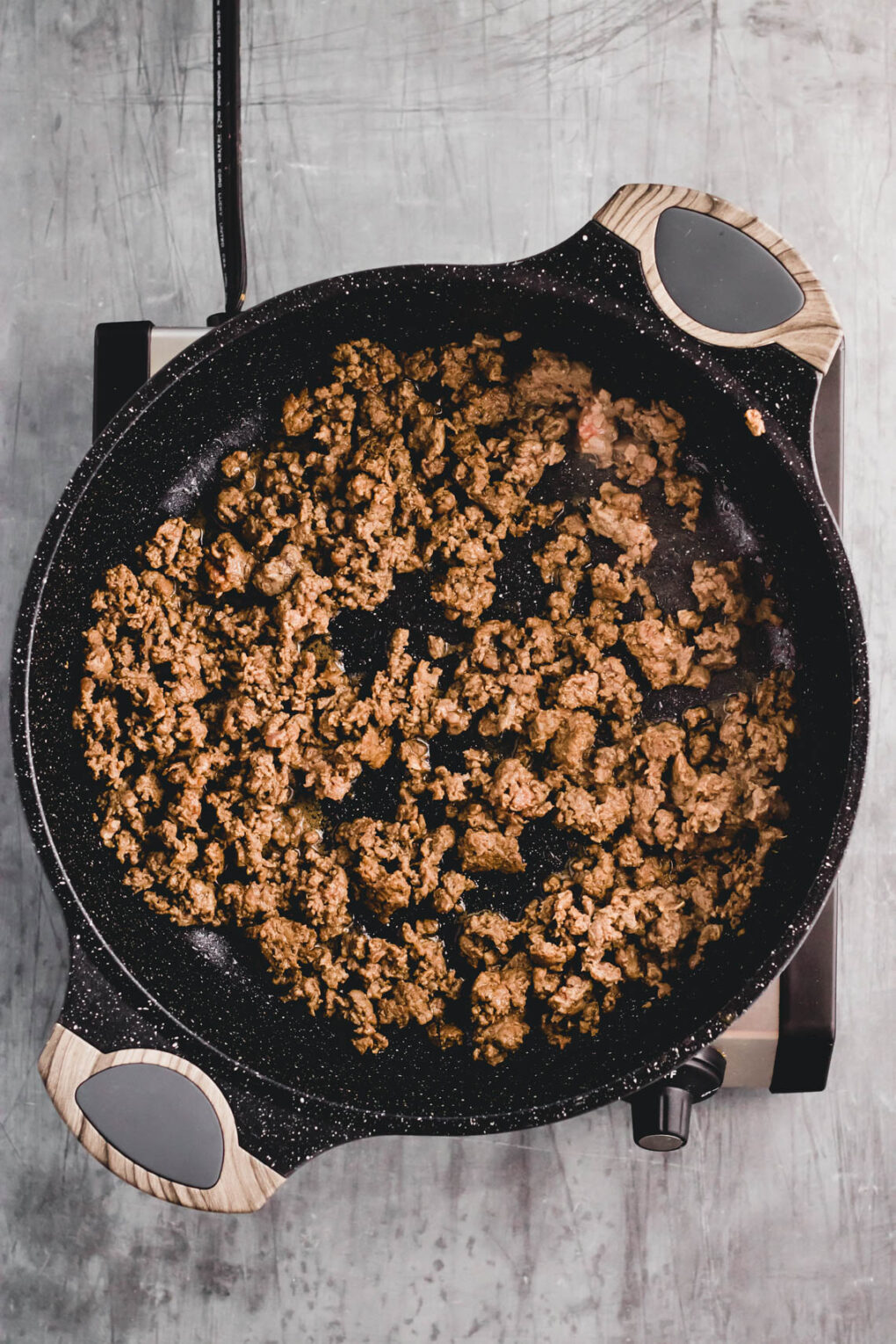 ground venison cooking in a skillet