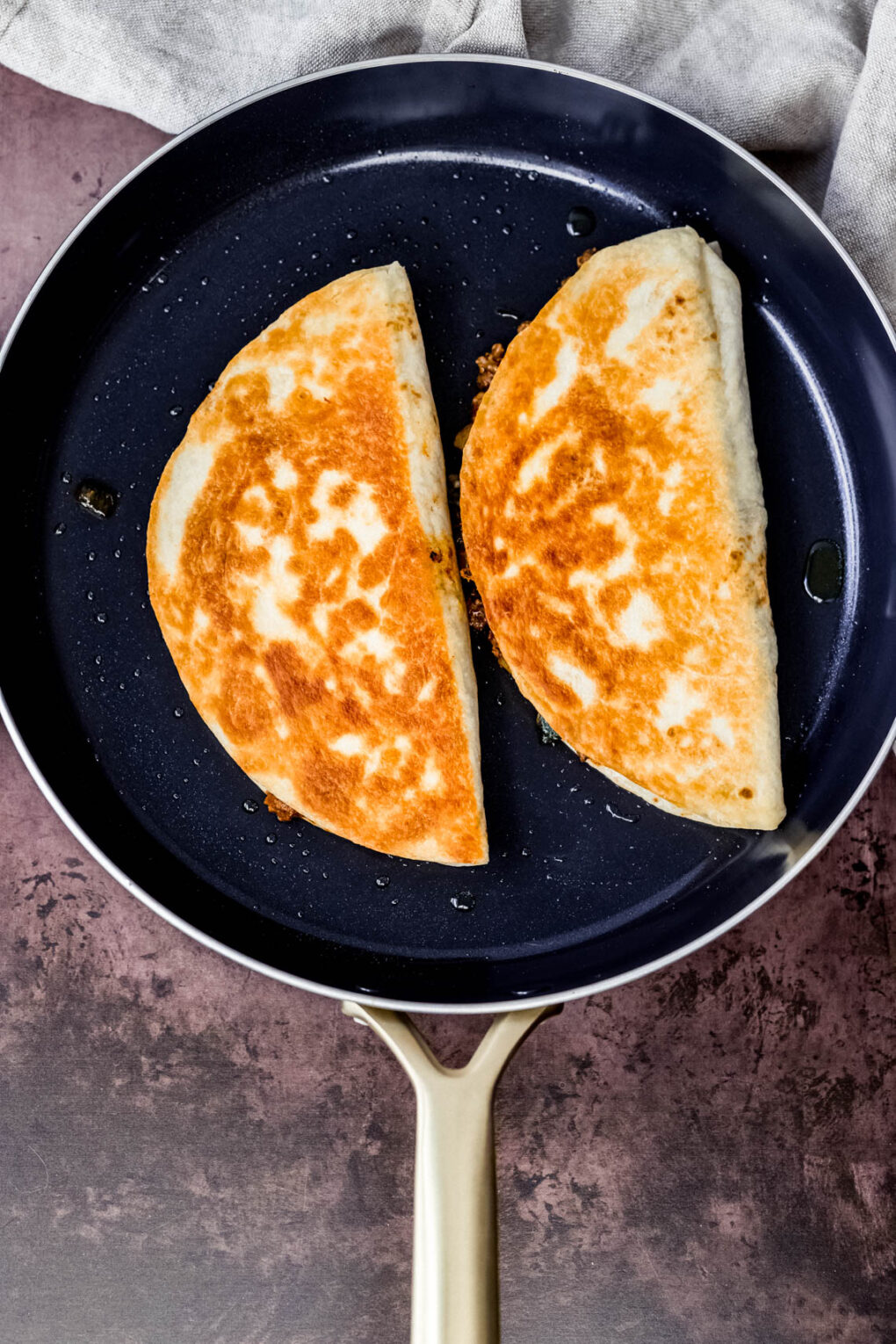 venison quesadillas cooking in a skillet